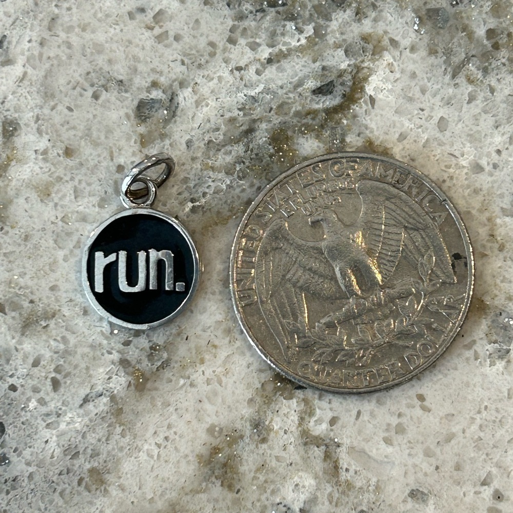 Silver and black run charm